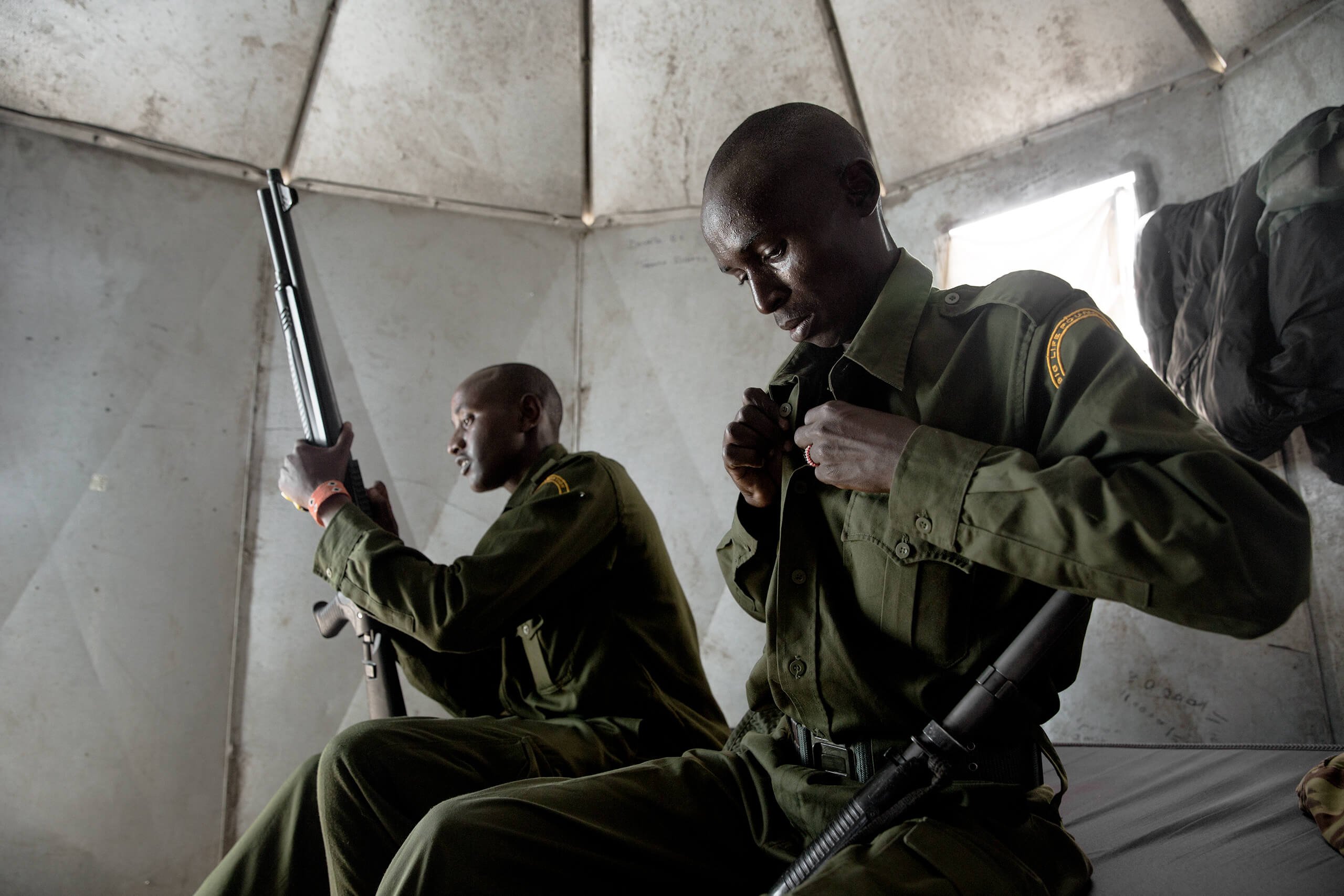 Inside one of the sleep quarters, the two prepare for patrol.  While Justus is James' boss, the two are very close friends.