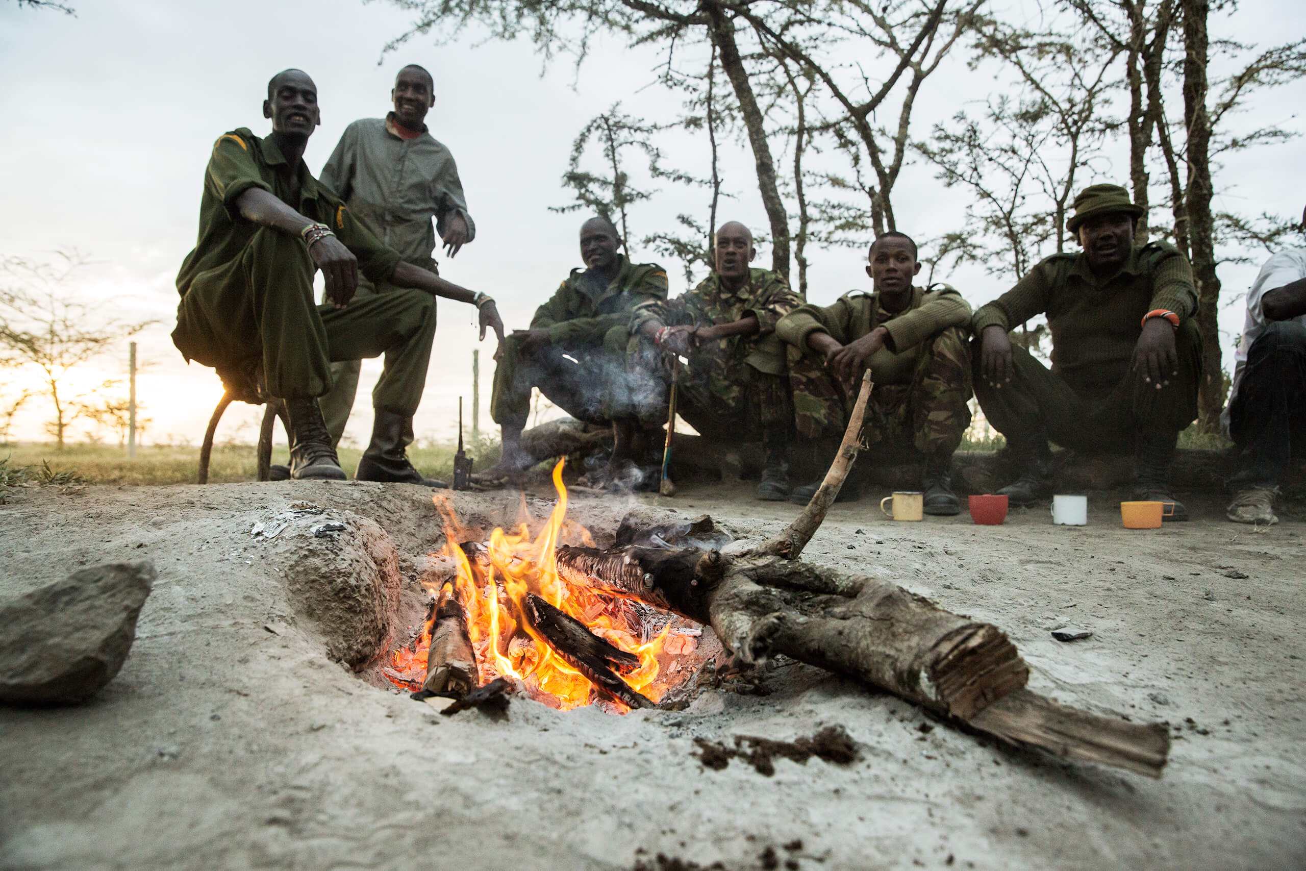 Caretakers and rangers at Ol Pejeta enjoy tea by the fire after the day shift.